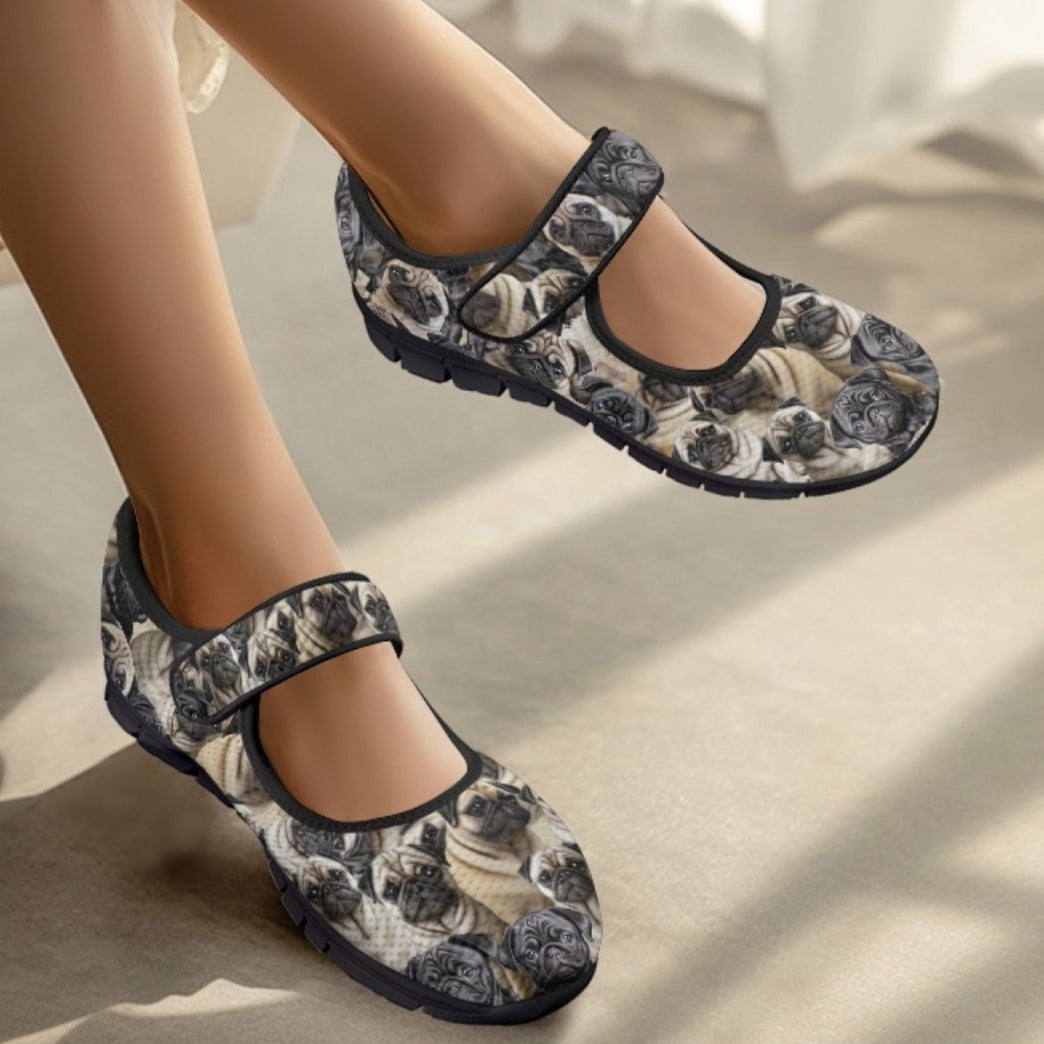 Pug shoes worn by a person sitting on a couch.